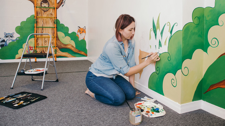 Woman painting a mural