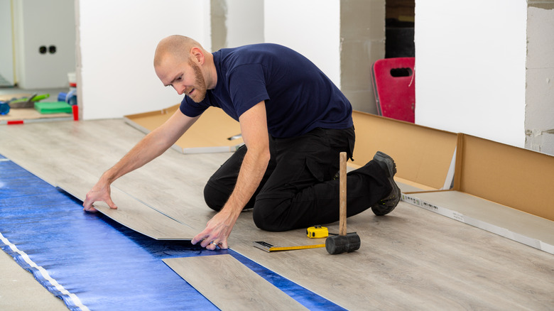 Man installing vinyl flooring