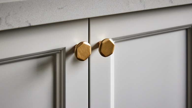 Round gold knobs on cabinets