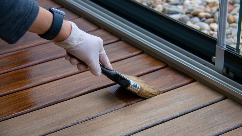 Staining hardwood floor with brush