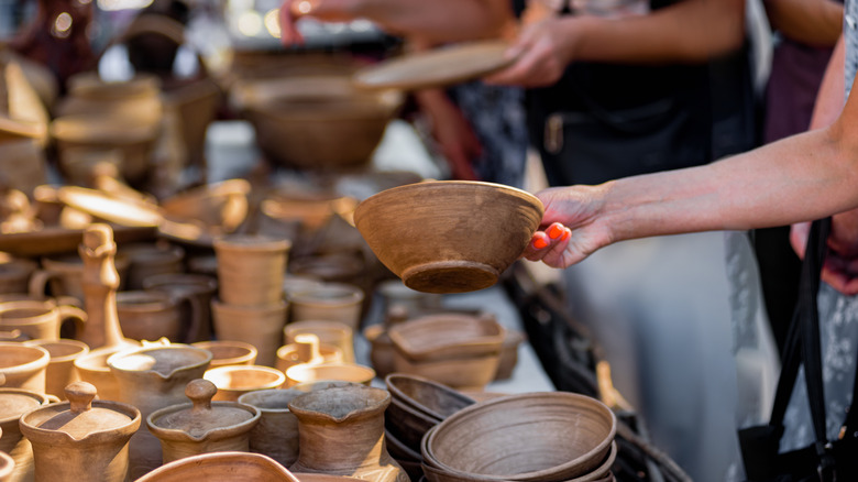 Buying pottery at a market