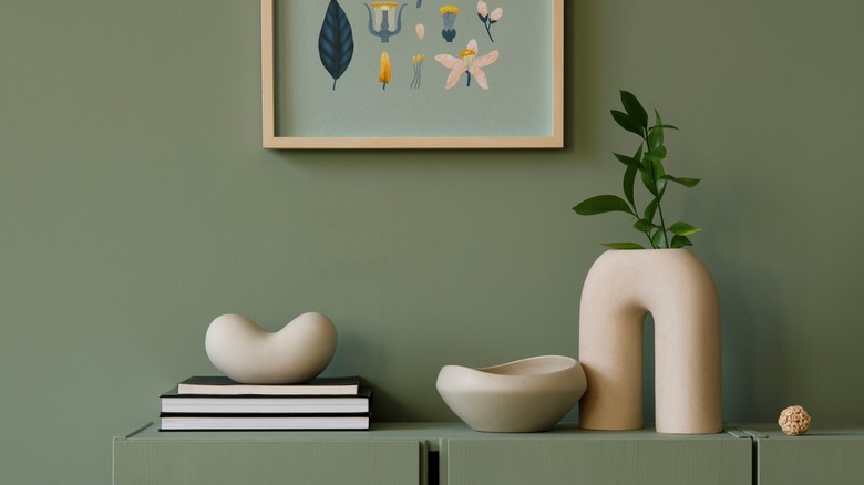 Jesmonite decor on green shelf