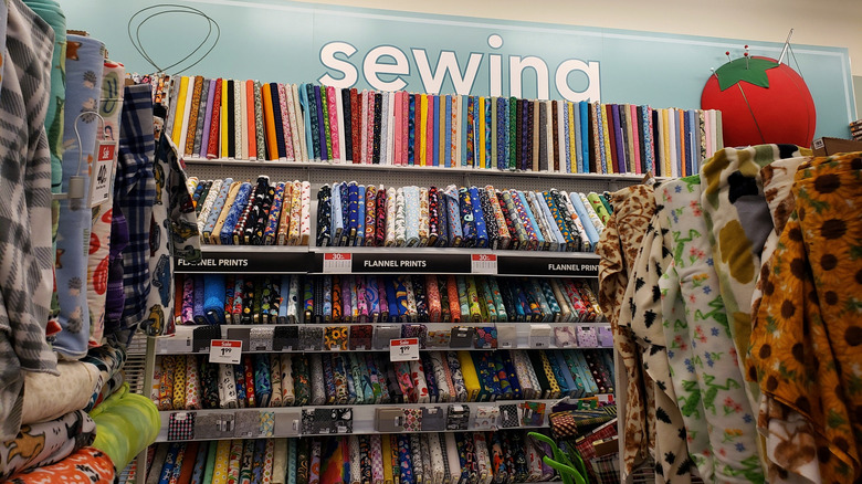 A sewing aisle in Joann Fabrics displays discounted fabric.