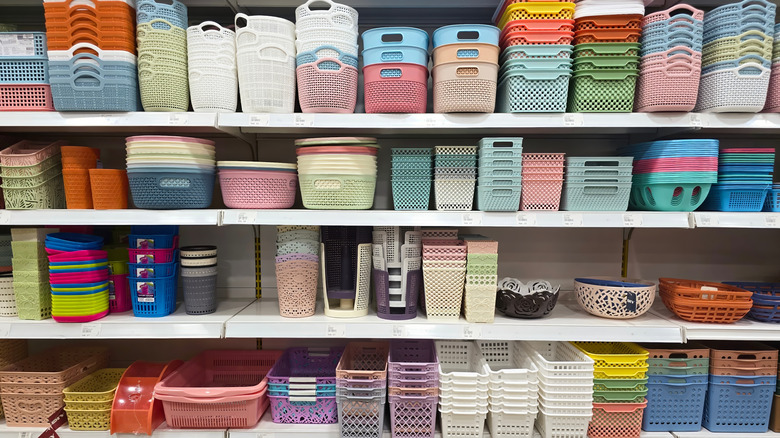 A store aisle is full of a variety of plastic storage containers.