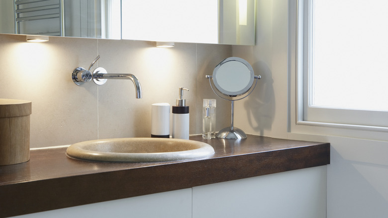 Undercabinet lights in white bathroom