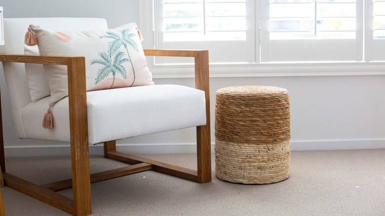 A coastal-style wooden chair and foot stool