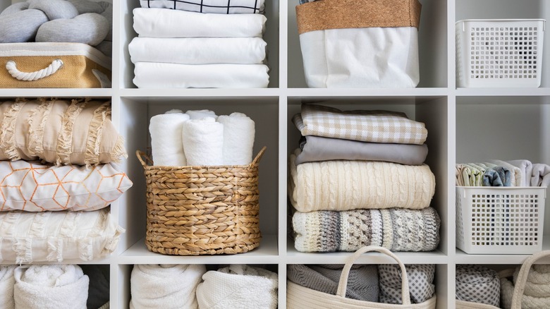 Cubby storage shelf with baskets and blankets