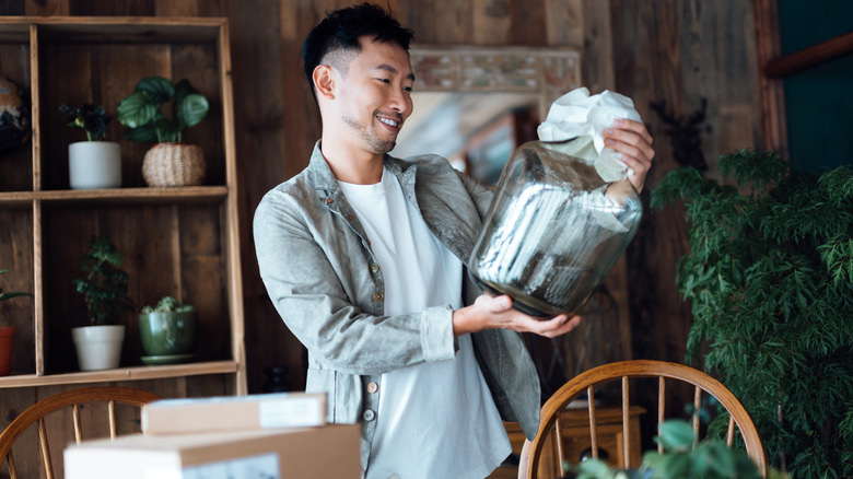 Man looking at a vase