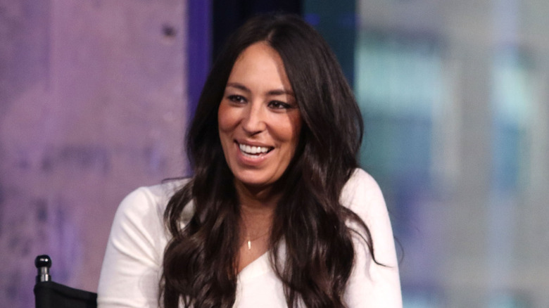 Joanna Gaines smiling wearing a white shirt