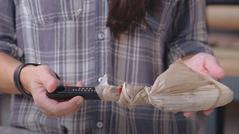 Paintbrush wrapped tightly in bag