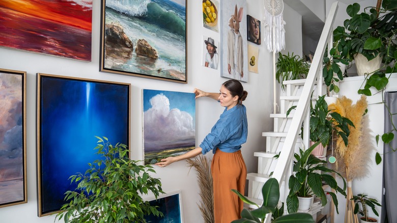 woman hanging art