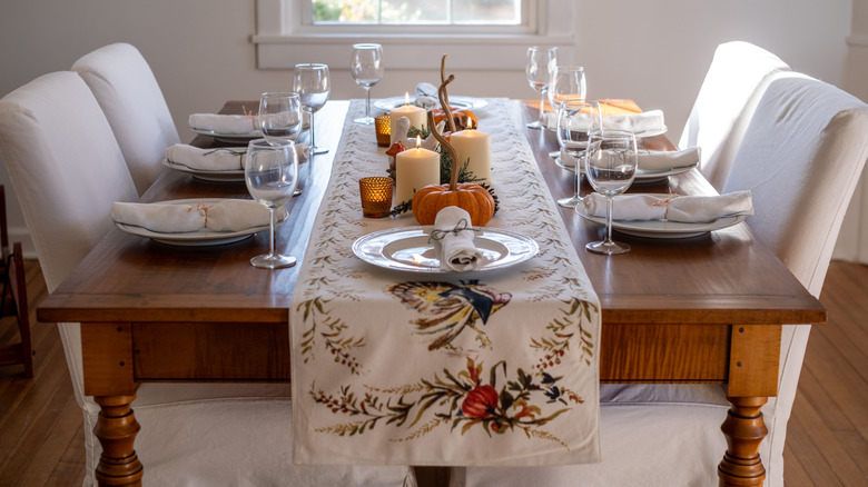 Thanksgiving table with pumpkins and candles