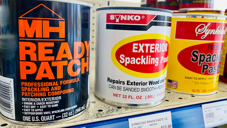Cans of spackle on store shelf