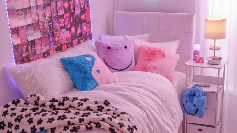 Pink dorm room with happy face pilllow