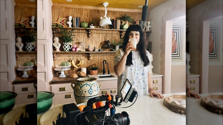 Katie Saro drinking coffee on set