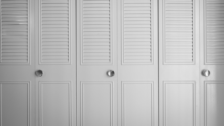 White bifolding closet doors with silver handles