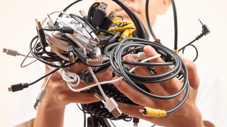 Person holding a mass of tangled wires