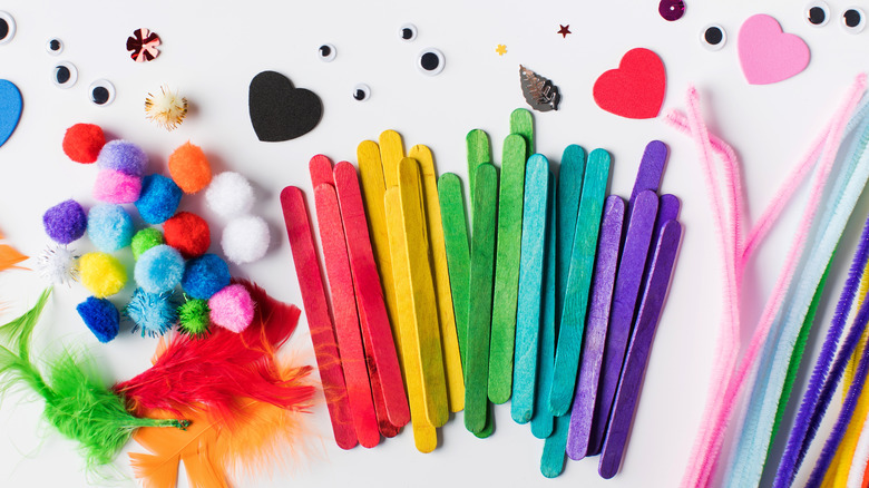 Colorful pipe cleaners, popsicle sticks, and other craft supplies