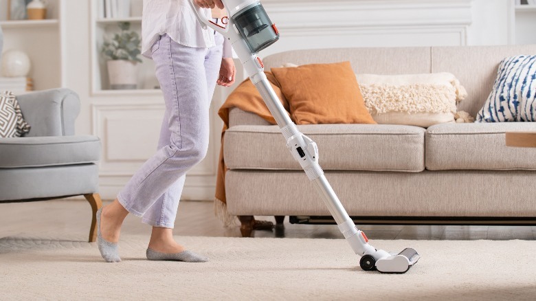 Woman using cordless vacuum