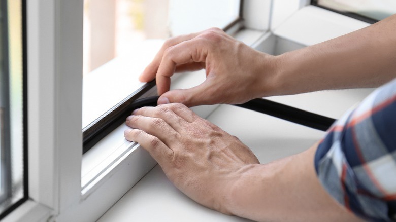 Putting weatherstripping on windoe