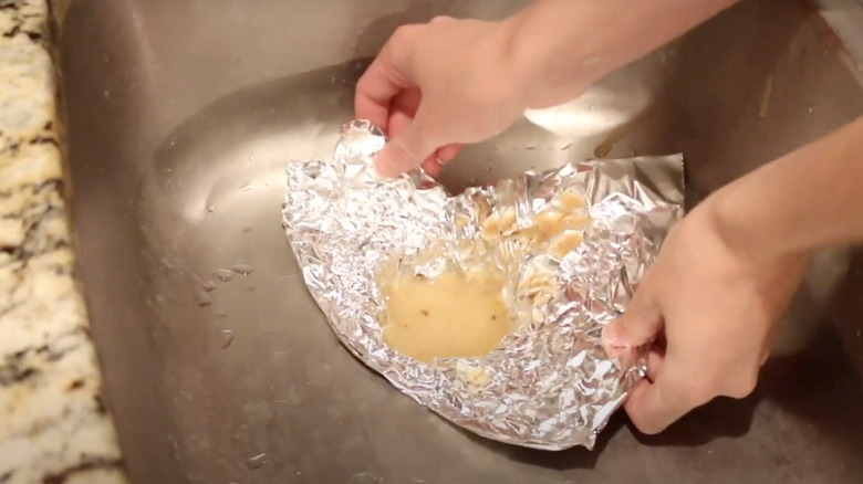 Person holding solidified grease