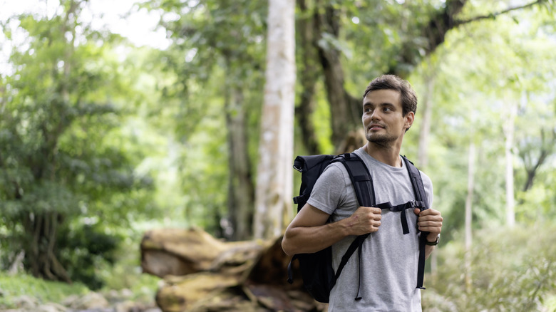 Hiker wearing light grey shirt