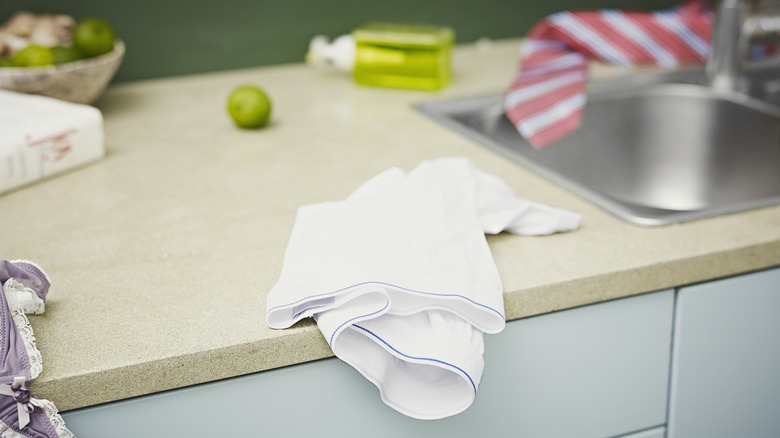 Counter cluttered with dish towels