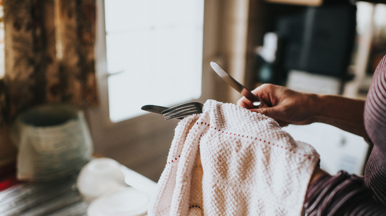 Person washing cutlery