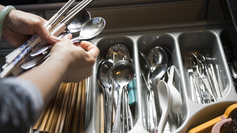 Person organizing utensils