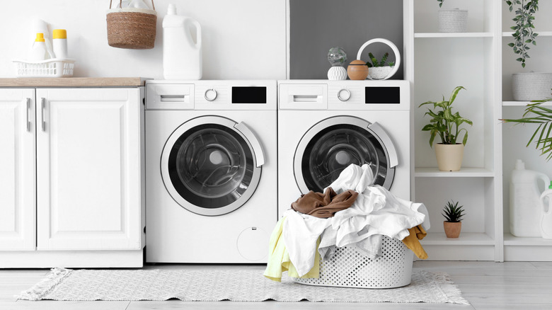 Laundry room appliances with laundry basket in front