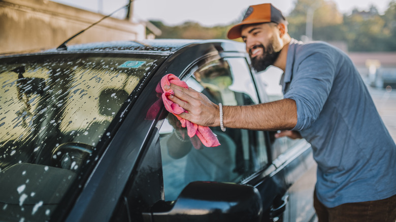 A man cleaning his car 