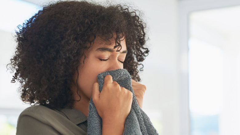 Woman smelling fresh towel