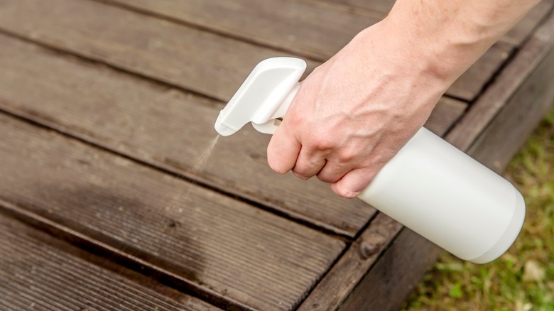 spraying wooden patio deck