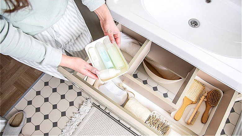 Person storing items in vanity 