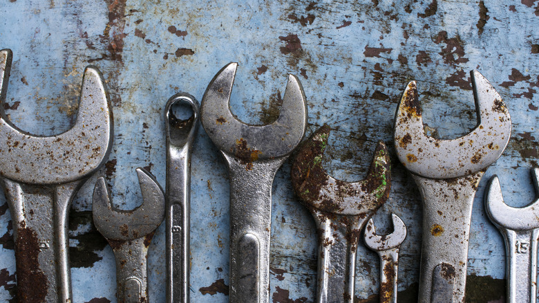 A row of rusted hand wrenches