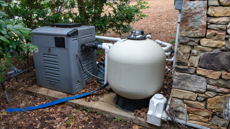 Pool pump, filters, and pipe work exposed outside of home