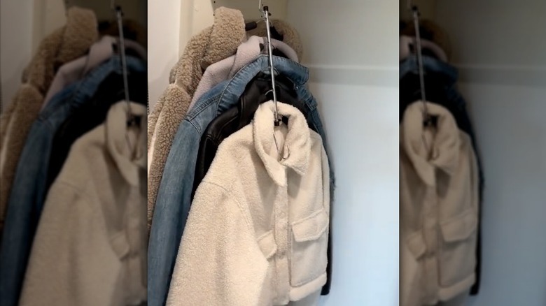 Coats hanging on collapsible hanger in closet