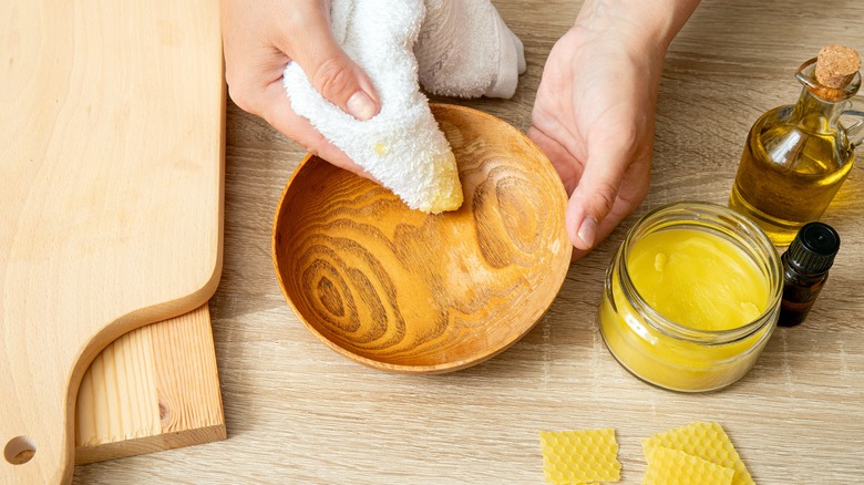 applying wood polish on wooden plate