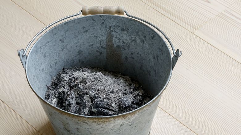 wood ash in metal bucket