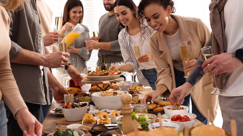 Friends and family enjoy a buffet style meal