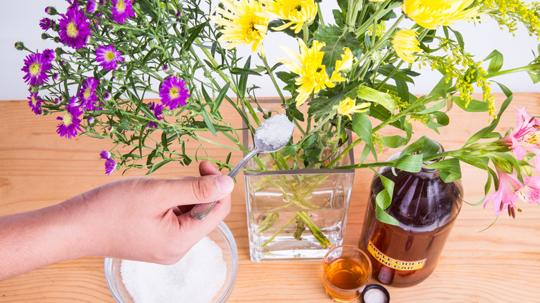 Adding sugar to flower vase