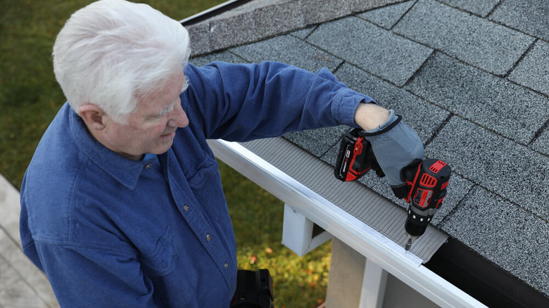 Man installing gutter guards