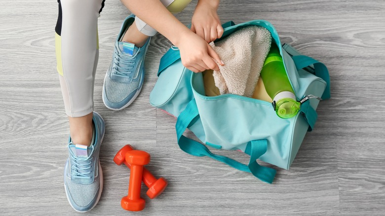 Woman packing gym bag