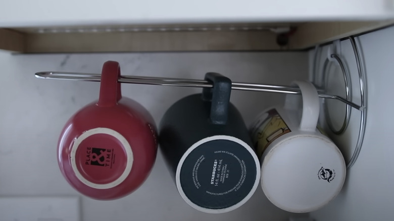 mugs hanging from paper towel rack