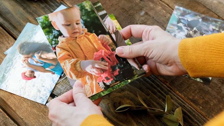 Hands holding photo of child