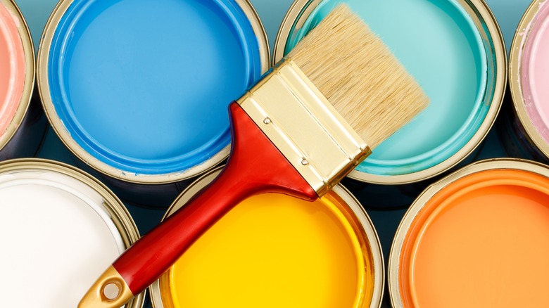 cans of paint and brush