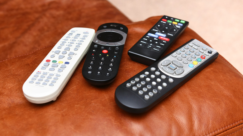 collection of four TV remotes