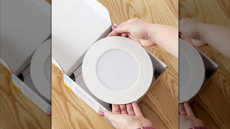 Person removing the Brilli recessed light from a box