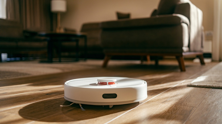 Robotic vacuum on hardwood living room floors