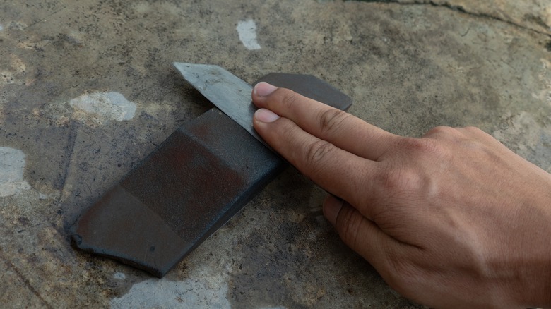 sharpening utility blade on stone